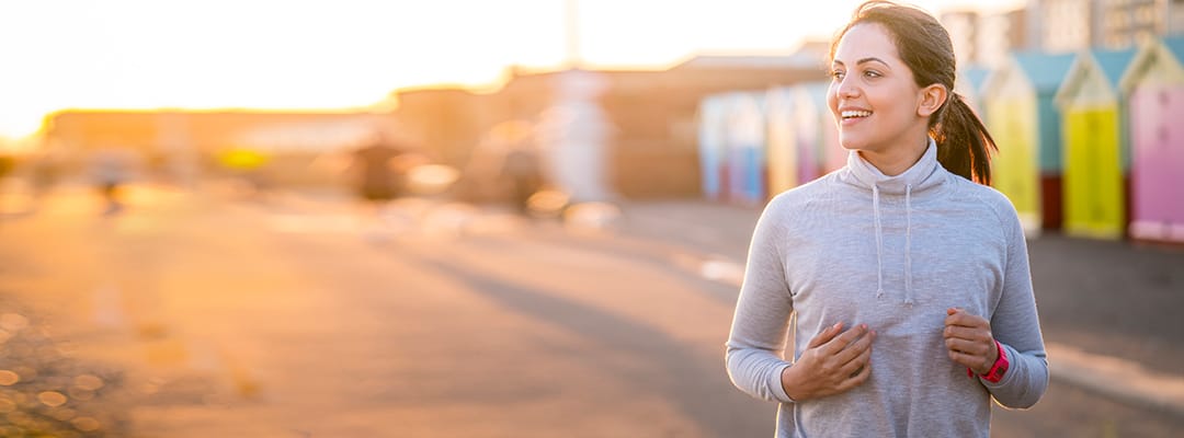 Woman jogging on boardwalk using magnesium supplement for whole body health