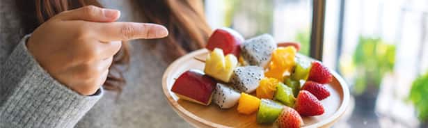 Woman pointing at platter of food