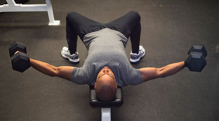 Man weight training on a workout bench