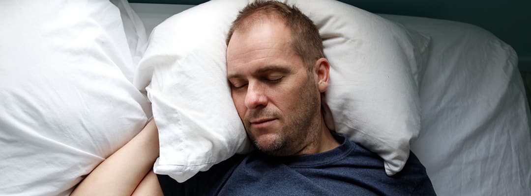 Man supplementing with glycine to help sleep
