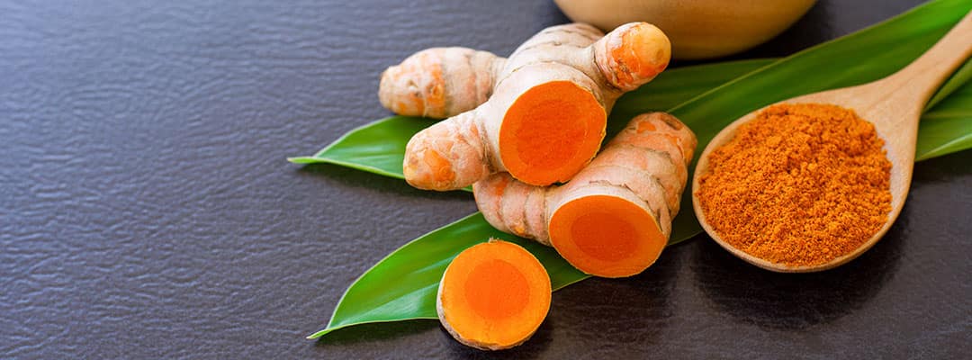 Curcumin from Turmeric root in a clay bowl