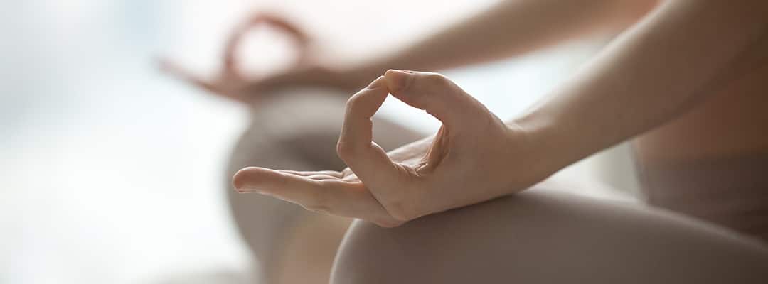 Woman doing yoga to benefit whole body and mind health