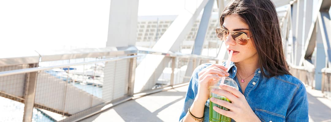 Young woman getting vitamin D from a vegan drink