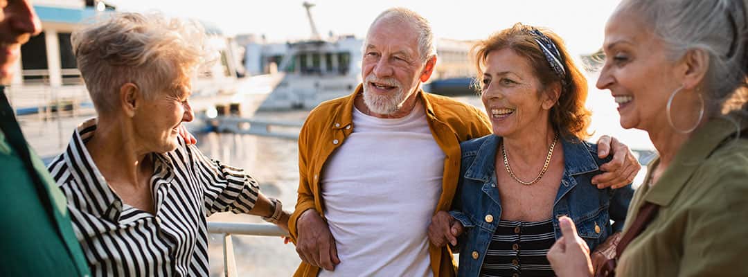 Group of youthful—physically and mentally senior friends chatting on the boat